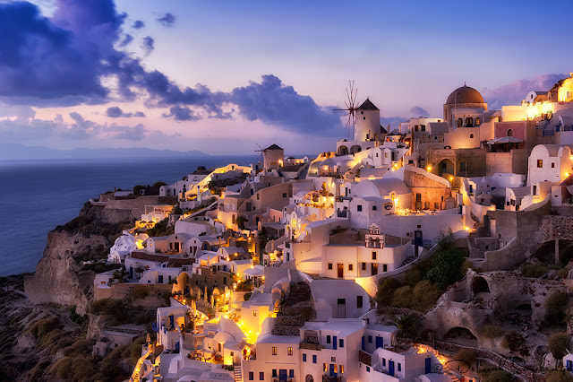 Village of Oia Santorini at twilight with purple sky and clouds