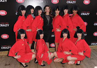Kelly Brook posing with the dancers of Crazy Horse 