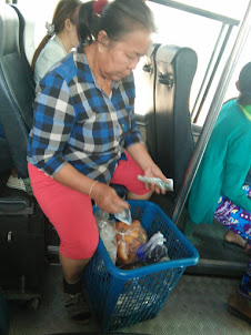 A hawker selling her wares in "Bus N0 14".