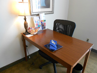 a desk with a lamp and a napkin on it