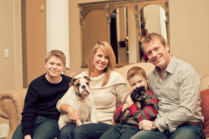 Charles Billingsley with his wife and two kids a studio photo