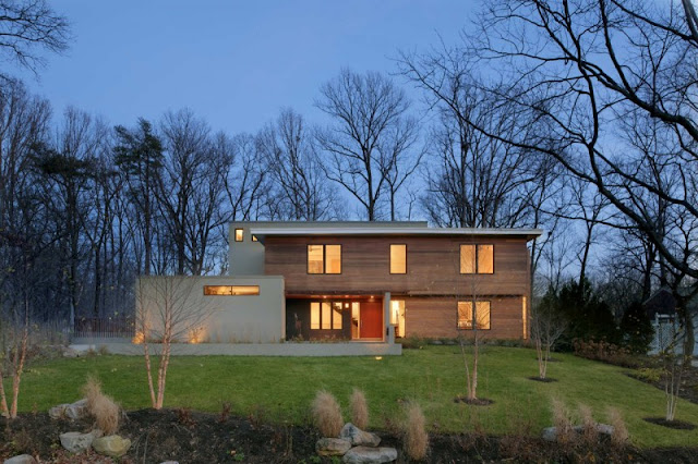 Light Brown Outer Wall Made from Wooden Material and Vast Green Grass Garden