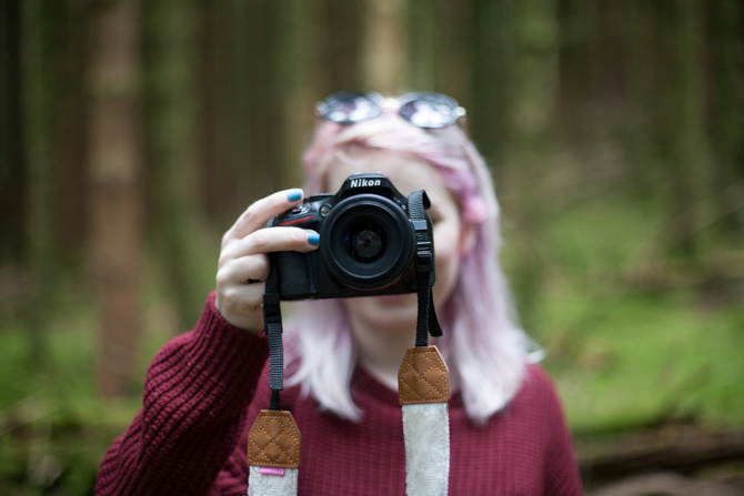 girl holding nikon dslr camera