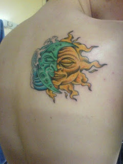 Sun and Moon tattoo; the sun and the moon are depicted as two creepy human faces