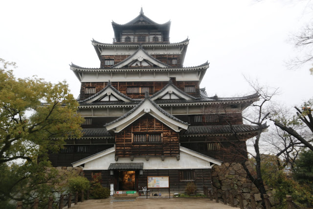 The main entrance of the reconstructed of 5 levels of Hiroshima Castle on top of the hill in Hiroshima, Japan The main entrance of the reconstructed of 5 levels of Hiroshima Castle on top of the hill in Hiroshima, Japan