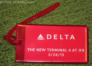 a red luggage tag with white text
