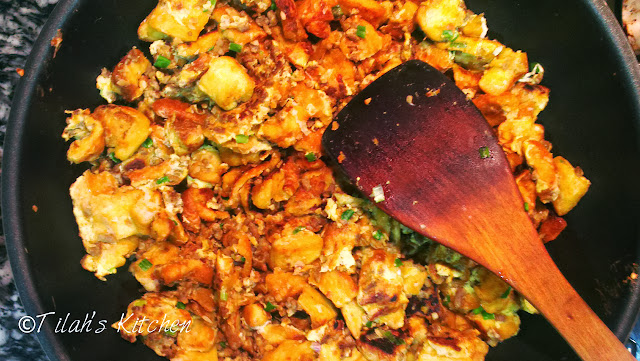 A fried dish with preserved radish (chai por) and egg just like the Chinese style fried carrot cake substituted with bread and added with minced beef.