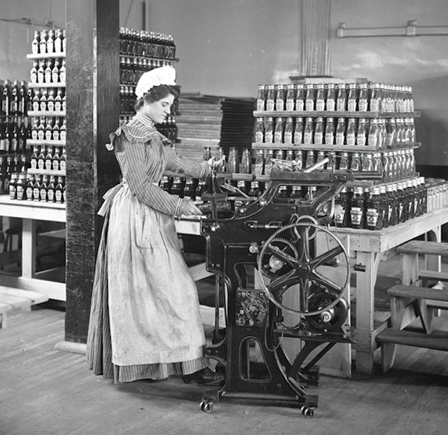 Female worker bottling ketchup at the original Heinz factory in