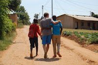 Andrew walks away in celebration after completing Umuganda with ROP volunteers.