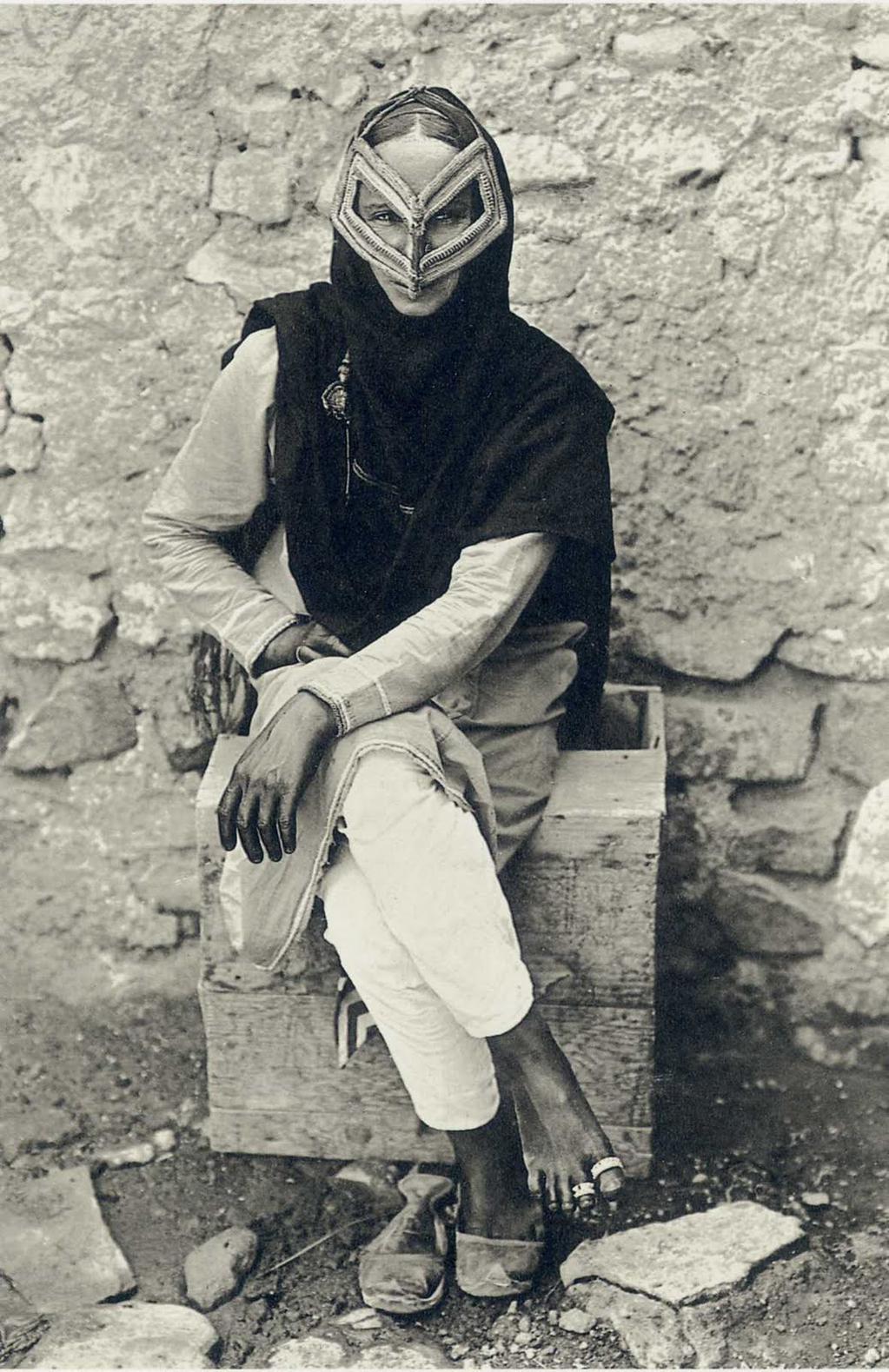 Portrait of an Arab woman wearing a traditional face mask in Muscat