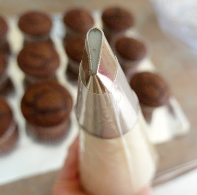 use frosting bag and tip to create mummy strips on cupcake