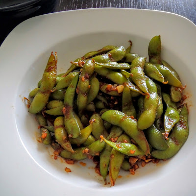 Spicy Edamame:  Young soybeans, in the pod, sauteed in ginger, garlic, soy sauce, and sriracha.  A spicy, salty, and nutritious snack.