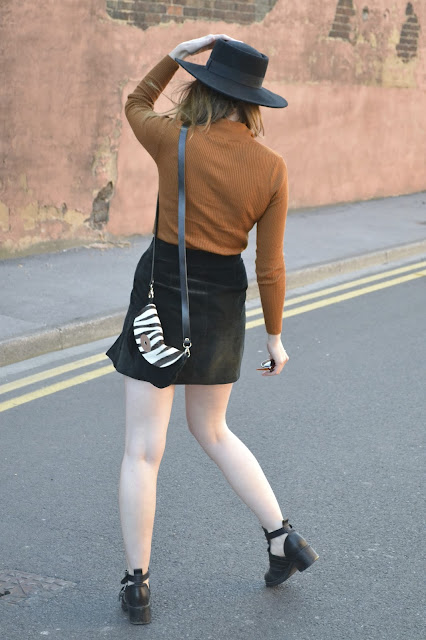 womens affordable highstreet fashion blog featuring British street style. Primark 70's style brown ribbed fitted top. Vintage Black suede skirt with slit up one side. Black topshop boots with cut. Asos matador hat in black felt. TK Maxx zebra print bag.