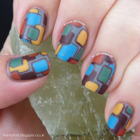 Rectangular stamped nail art in a 1970s-inspired color scheme and pattern.