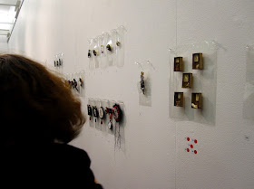 View of a gallery displaying art brooches.