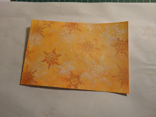 Orange salt background with snowflakes in ink and white mica powder