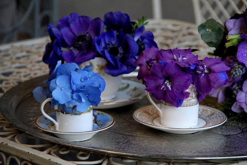 The blue cup has a tiny posy of blue Hydrangeas the gold cup purple 