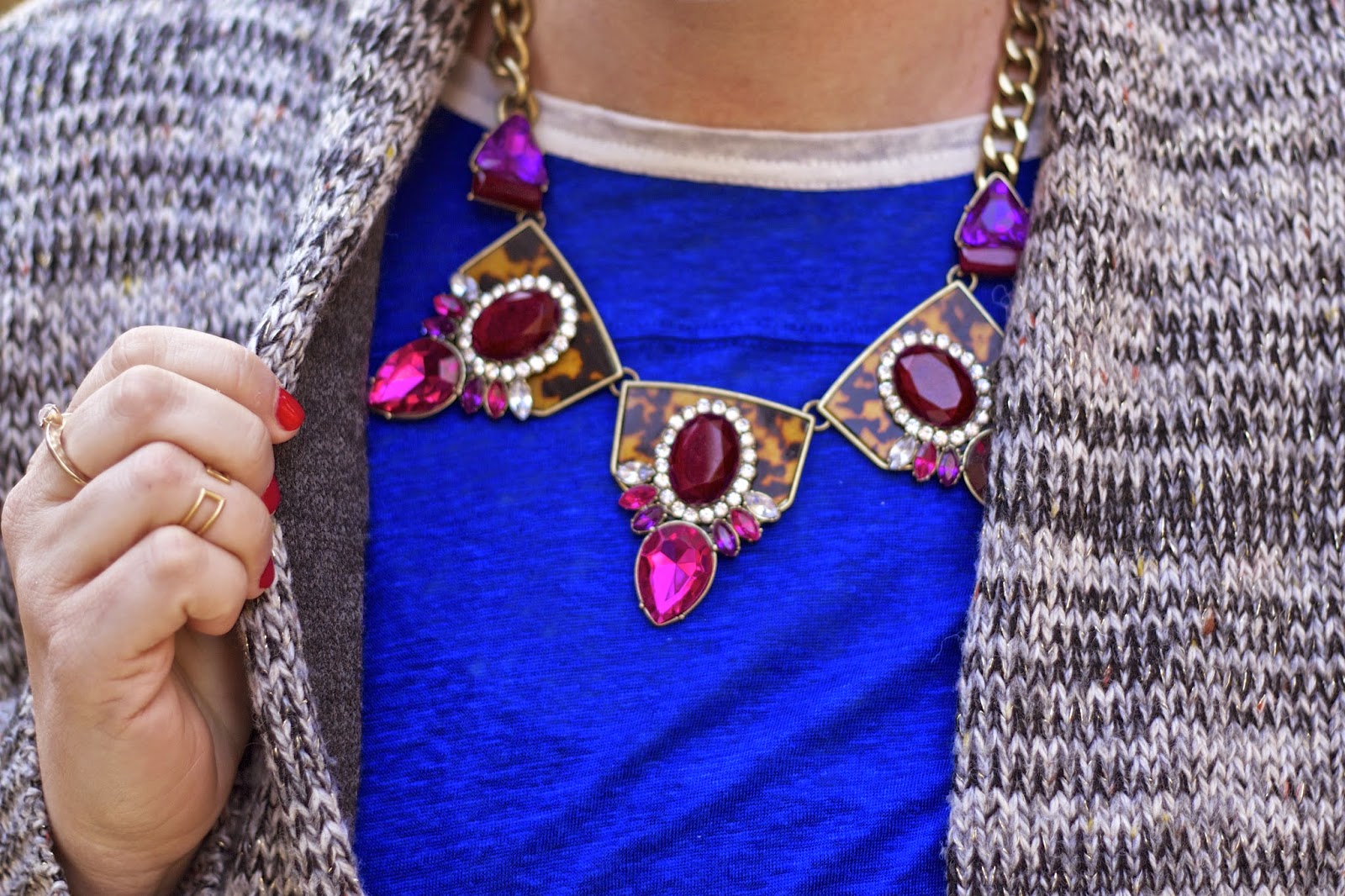 wearing a statement necklace with winter sweater