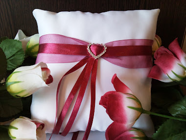 white cushion with burgandy ribbon and silver heart £8.50