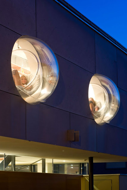 Hanging Bubble Chairs near the Bright Interior Lighting