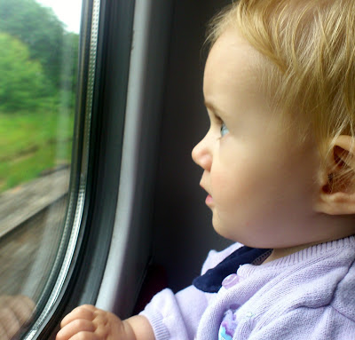 Single mother ahoy baby looking out train window