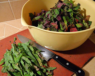 Bowl of Kale Strips with Kale Strips Being Cut on Cutting Board