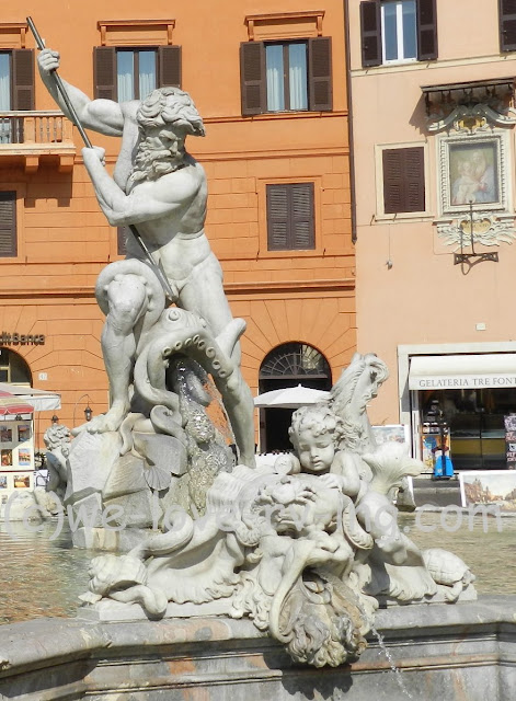 Neptune and a young boy are part of the fountain