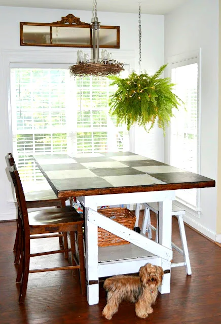 Checkerboard table with whimsical lighting by Down To Earth Style, featured on I Love That Junk - I love this space!