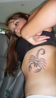 Scorpion tattoo on the side of the body of a young woman