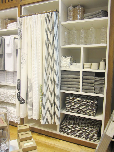 White cabinet holding a variety of black, white and grey bath accessories