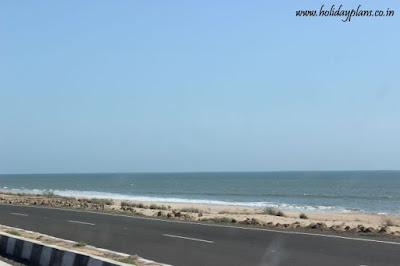 Scenic view of road & sea adjacent to each other Scenic view of road & sea adjacent to each other