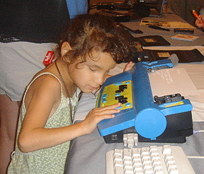 Source: nfb.org young girl using a Mountbatten Braille Writer
