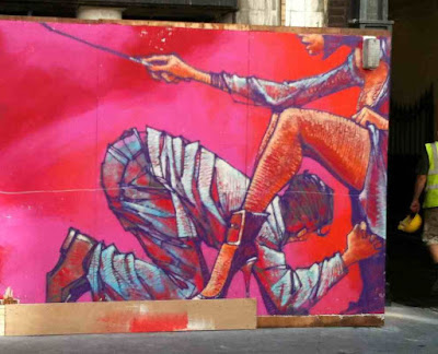 Life size mural of man bowing to a woman