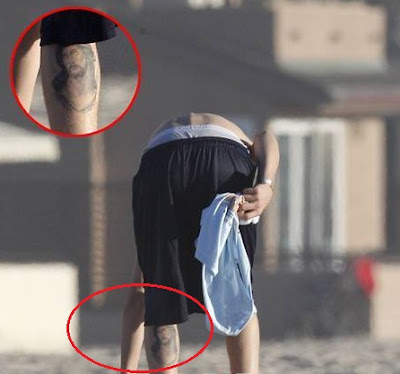 justin bieber en la playa sin camiseta y con tatoo de jesucristo en la pierna 2012