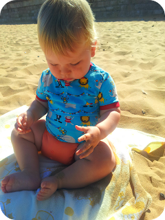 baby discovering sand