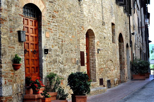 Wooden Doors along a Street in San Gimignano, Italy | Taste As You Go