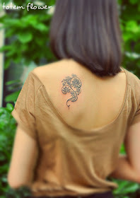 exquisite tribal flower tattoo design under the shoulder