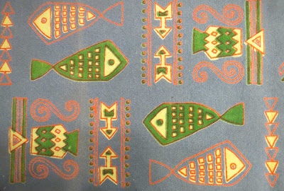 Tablecloth detail with green and bicolor fish