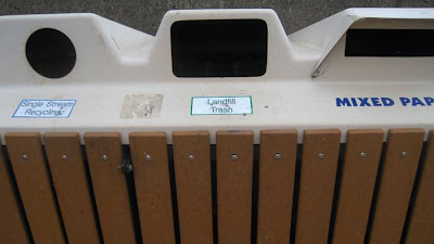 Recycling and trash receptacle labeled Landfill Trash