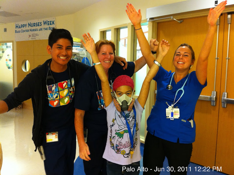 Amirah and the nurse doing a victory pose for the camera