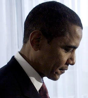 President Obama with head bowed