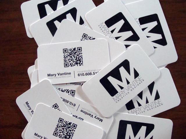 Mary Vantine business cards scattered on the table with a QR Code on the backside