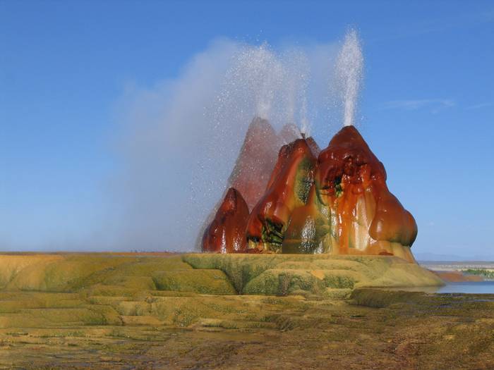 Fly Geyser is a little-known tourist attraction, even to Nevada residents. It is located near the edge of Fly Reservoir and is only about 5 feet (1.5 m) high, (12 feet (3.7 m) counting the mound on which it sits). The Geyser is not an entirely natural phenomenon, and was accidentally created in 1916 during well drilling. The well functioned normally for several decades, but in the 1960s geothermally heated water found a weak spot in the wall and began escaping to the surface. Dissolved minerals started rising and accumulating, creating the mount on which the geyser sits, which continues growing. Today water is constantly spewing, reaching 5 feet (1.5 m) in the air. The geyser contains several terraces discharging water into 30 to 40 pools over an area of 30 hectares (74 acres). The geyser is made up of a series of different minerals, which gives it its magnificent coloration.