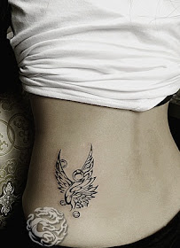 concise phoenix tattoo on the hip