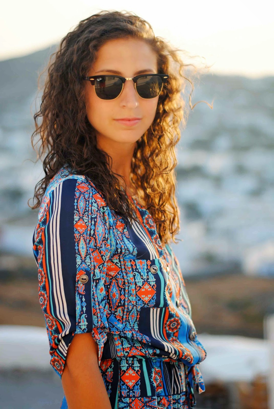 mykonos greece blue paisley romper ray ban clubmaster curly hair