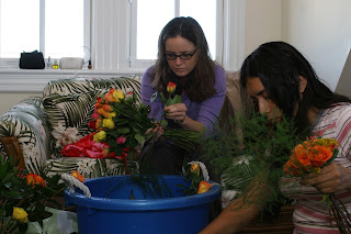 bride and bridesmaking making bouquets
