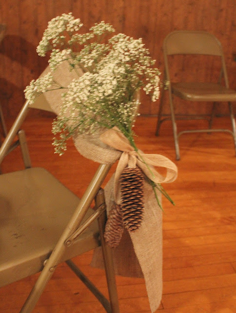 We also put some on the burlap and pinecone chair sashes lining the aisle