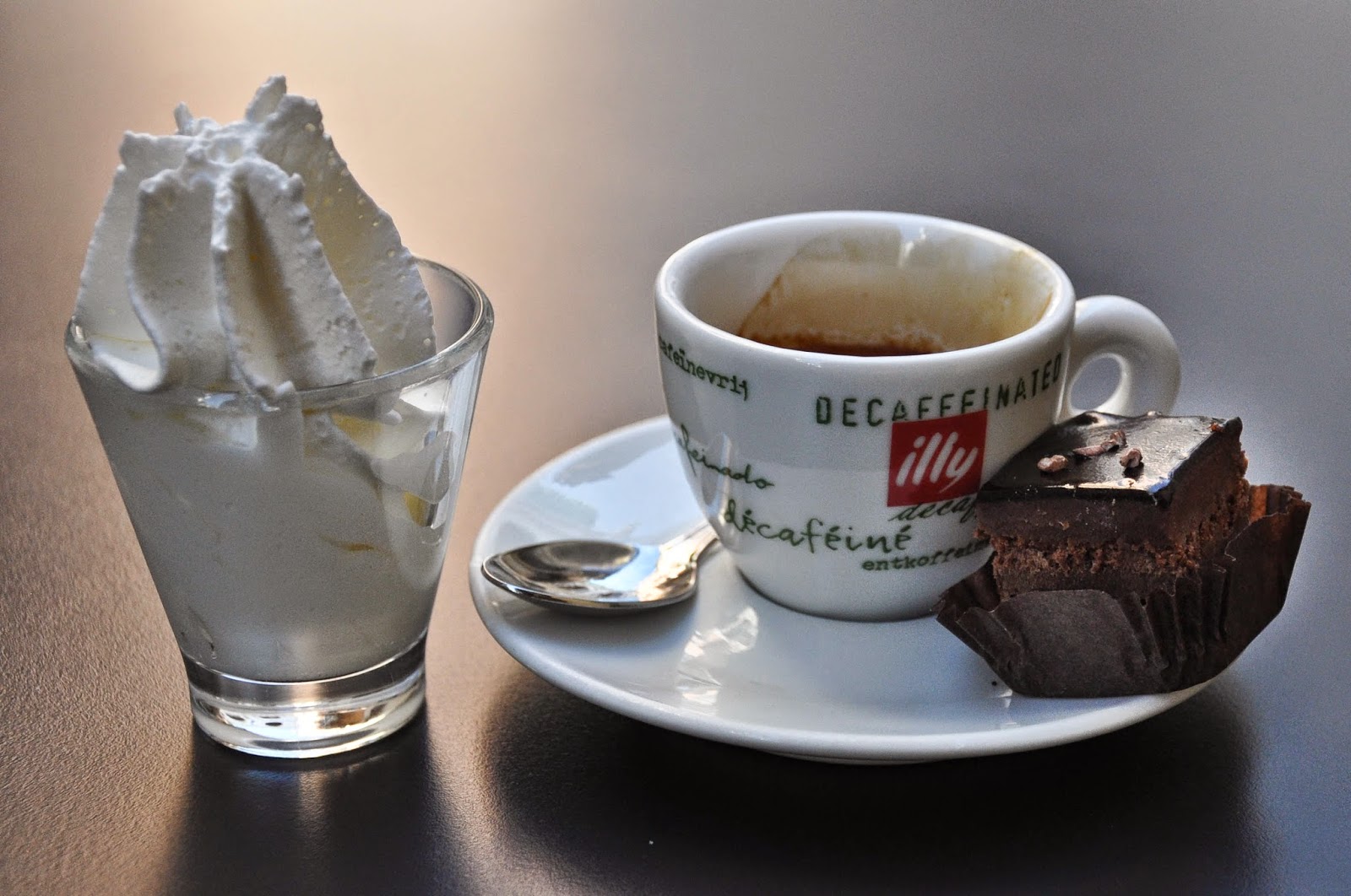 Espresso with a pot of whipped cream and an elegant sweet bite, Vicenza, Italy