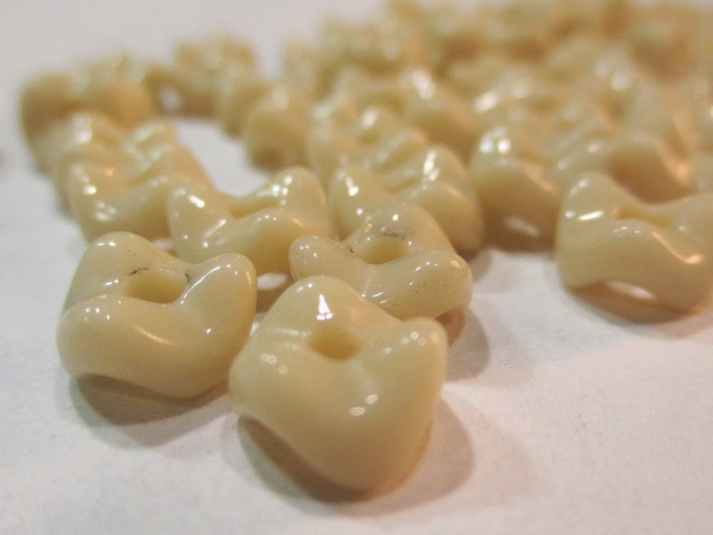 Cream glass vertebrae beads.