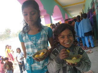 A little girl and boy at the Shekhwara Village School during lunch time